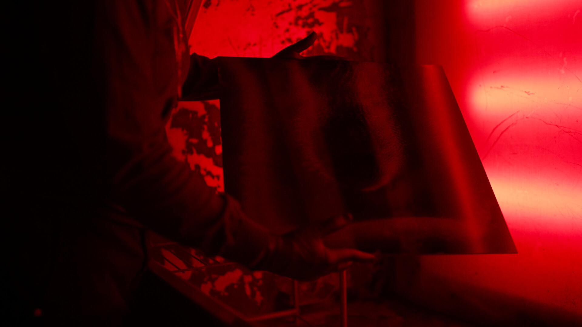 CYMATIC — darkroom process, developer tray under red light